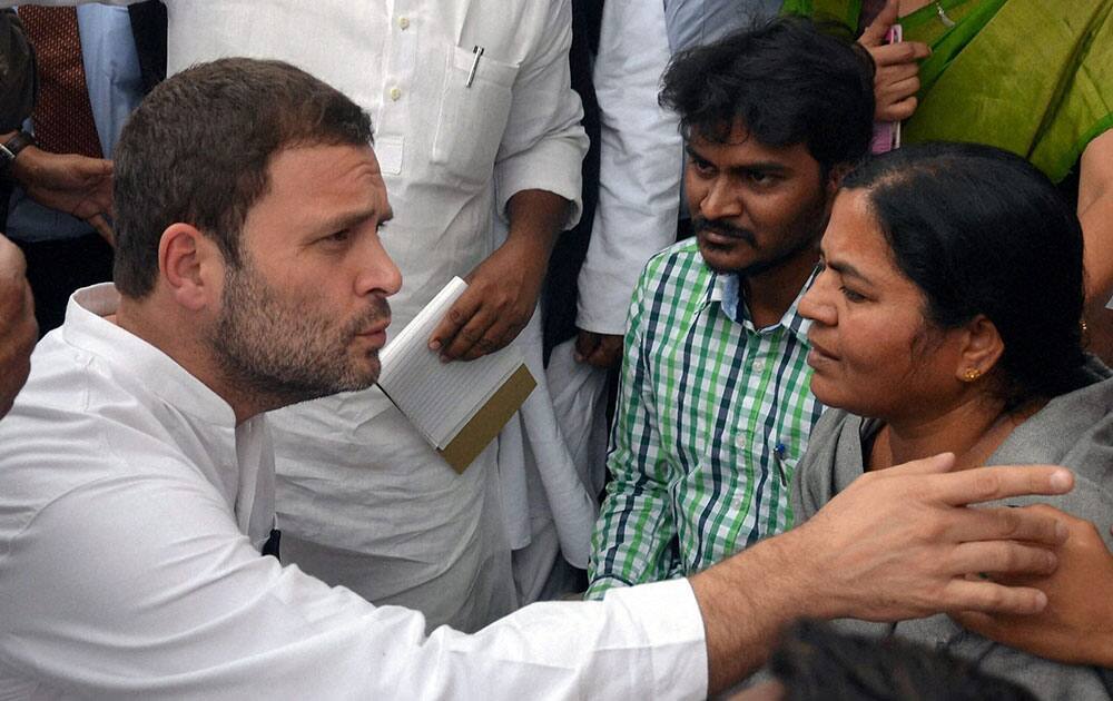 Congress vice-president Rahul Gandhi interacting with mother of research student Rohith Vemula who committed suicide at HCU Campus, in Hyderabad.