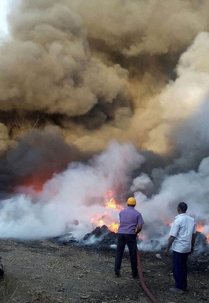 Fire personnel dousing a fire that broke out in a chemical godown at Khalapur Kumbhivali Village at Raigad.