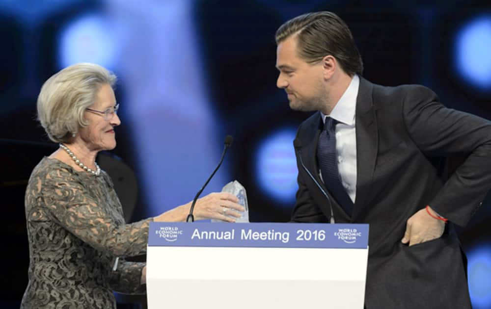 US actor Leonardo DiCaprio, right, receives a Crystal Award from German Hilde Schwab, left, Chairperson and Co-Founder of Schwab Foundation for Social Entrepreneurship.