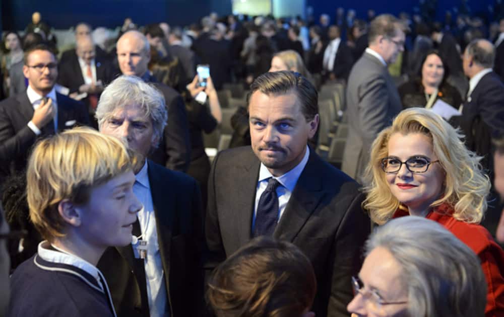 US actor Leonardo DiCaprio poses with participants after the Crystal Award Ceremony, on the eve of the opening of the 46th Annual Meeting of WEF.