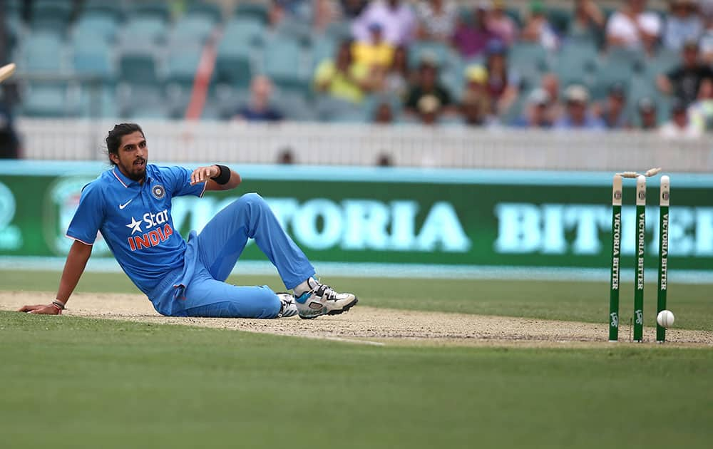 Ishant Sharma sits on the ground after he deflected the ball onto the stumps during their One Day International cricket match against Australia in Canberra, Australia.