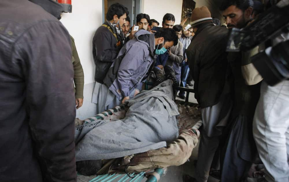 People carry the dead body of a terrorist at Bacha Khan University in Charsadda town.