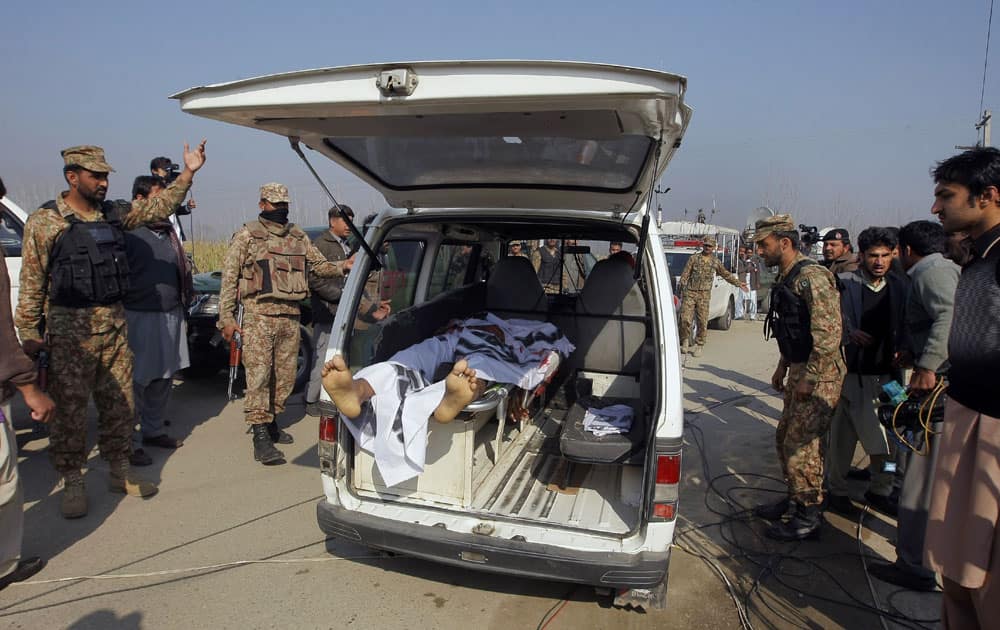 Pakistani troops clear way for an ambulance transporting a lifeless body of a victim from Bacha Khan University in Charsadda town.