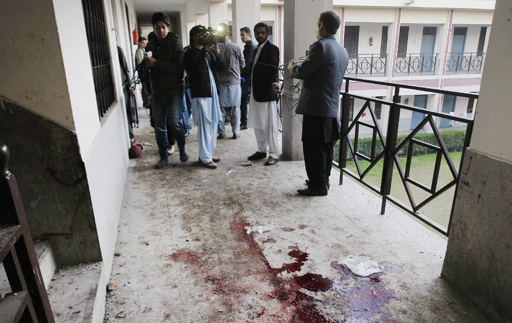 Reporters stand in a corridor at the Bacha Khan University in Charsadda town in Peshawar in Pakistan.