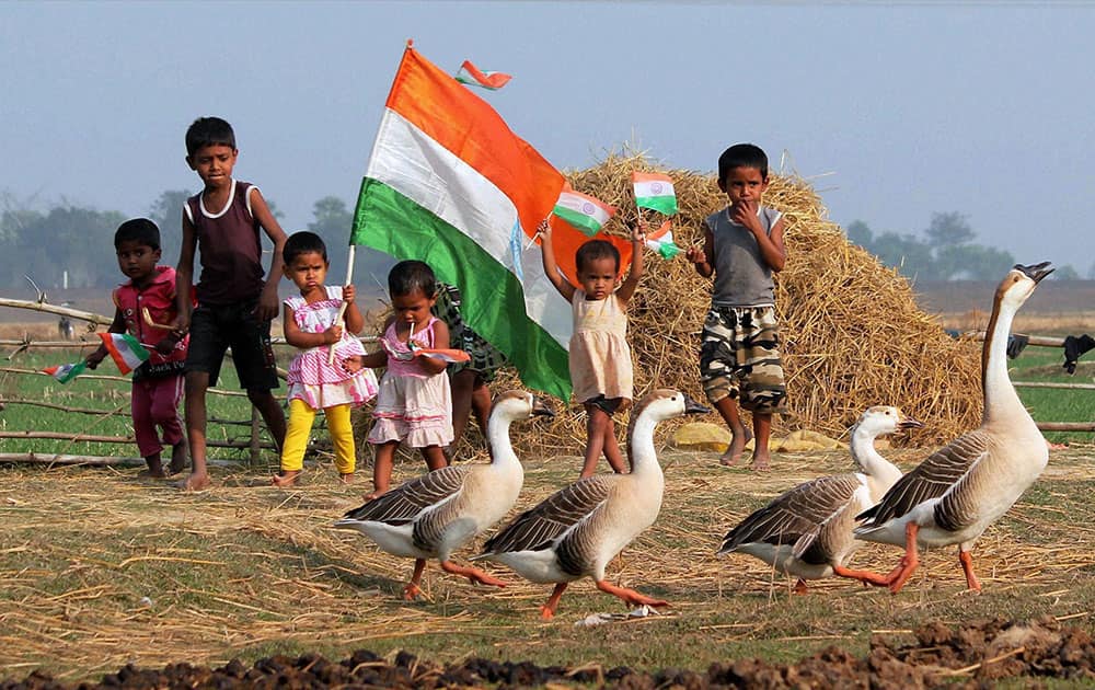 Children walk with National flags ahead of Republic day celebrations at a village near Balurghat in South Dinajpur district.