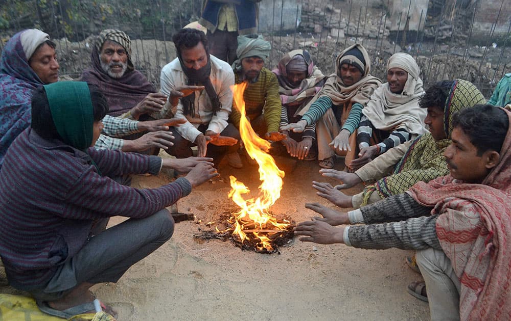 People warm themselves around a bonfire in Meerut.