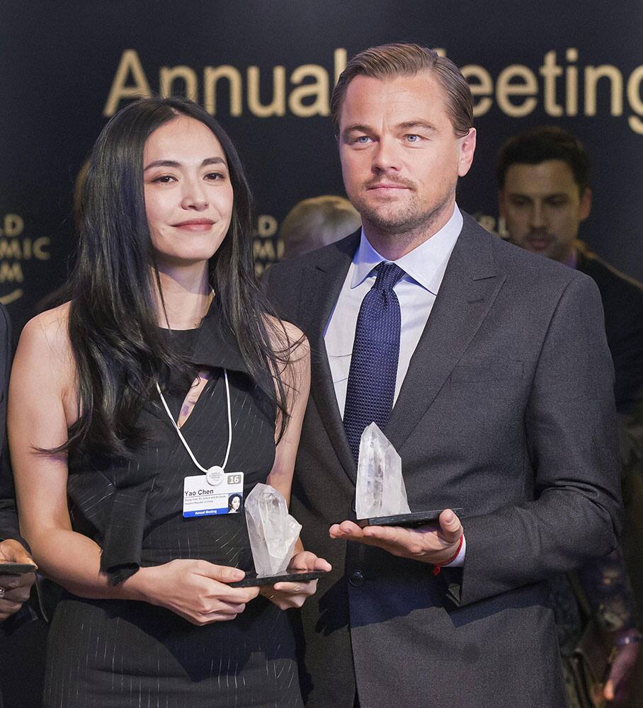 Chinese actress Yao Chen, left, and US Actor Leonardo DiCaprio pose with their trophies for media after Crystal Awards ceremony at the World Economic Forum in Davos, Switzerland.