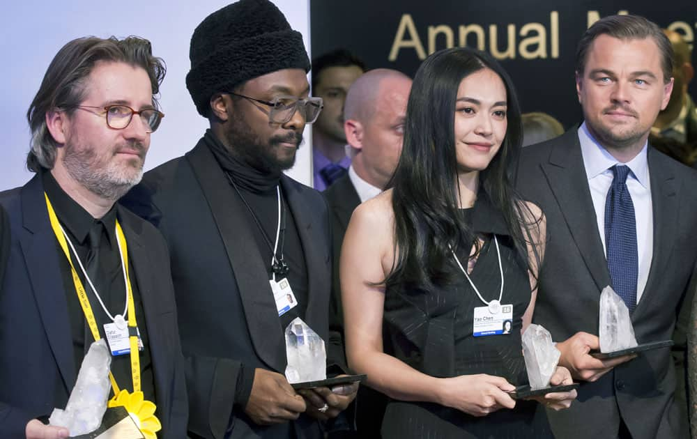 From left, Danish artist Olafur Eliasson, US singer, songwriter and rapper William Adams, Chinese actress Yao Chen and US Actor Leonardo DiCaprio pose for the media with their trophies after the Crystal Awards ceremony at the 2016 World Economic Forum in Davos, Switzerland.