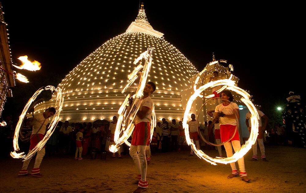 Sri Lankan fireball dancers perform during the inauguration of the annual Duruthu Perahera festival at Kelani Buddhist temple, in the outskirts of Colombo, Sri Lanka.