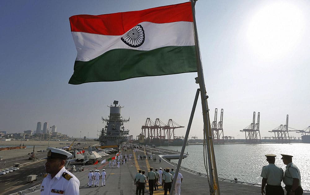 Sri Lanka security forces personnel walk on the landing deck of the Indias naval aircraft carrier INS Vikramaditya, which is on a goodwill visit to Colombo.