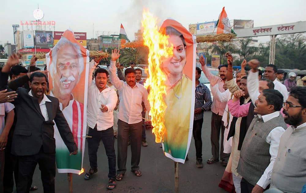 Congress workers burn effigy of HRD Minister Smruti Irani and Union Labour Minister Bandaru Dattatreya in protest against the death of Dalit student Rohith Vemula, in Bhubaneswar.