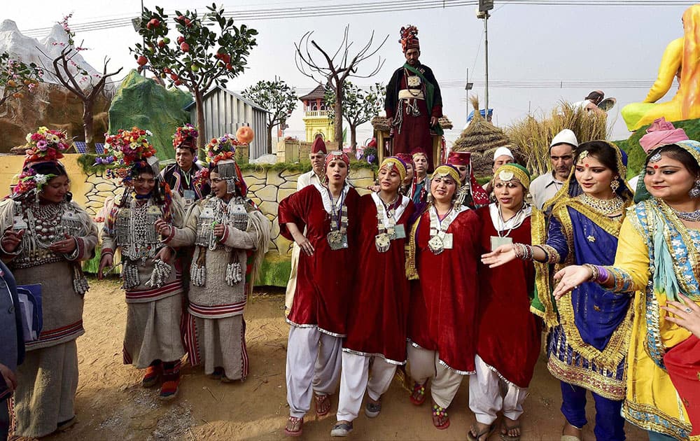 Jammu and Kashmir artists pose in front of their tableau for the Republic Day parade during a press preview in New Delhi.