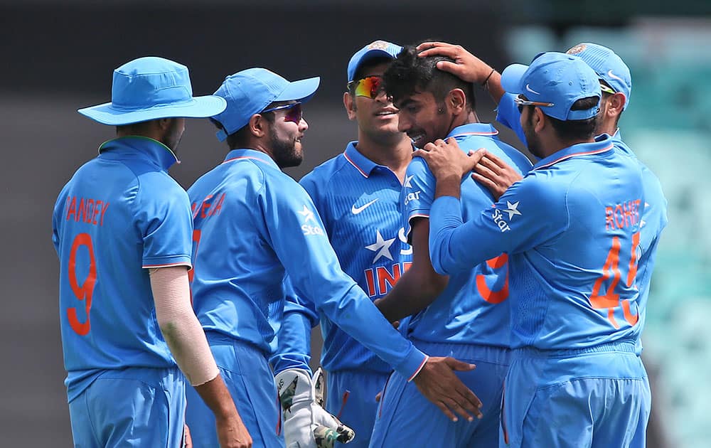 Jasprit Bumrah, second right, celebrates with team mates after taking the wicket of Australia's Steve Smith during their one-day international cricket match in Sydney, Australia.