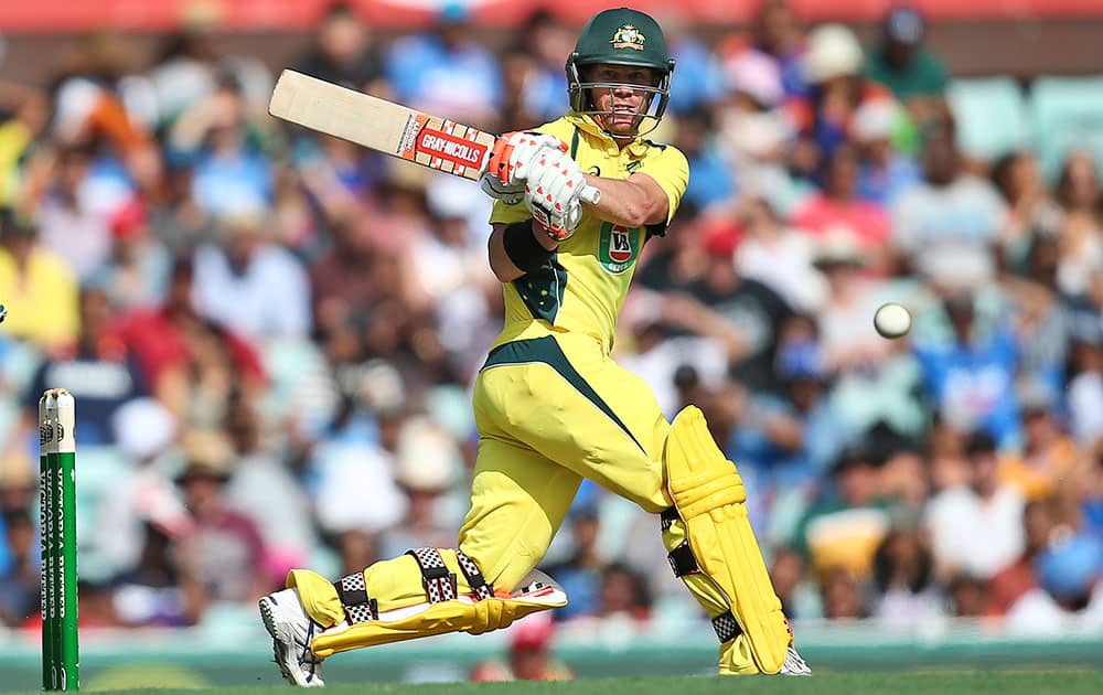 Australia's David Warner plays a shot on his way to a century during their one-day international cricket match against India in Sydney.