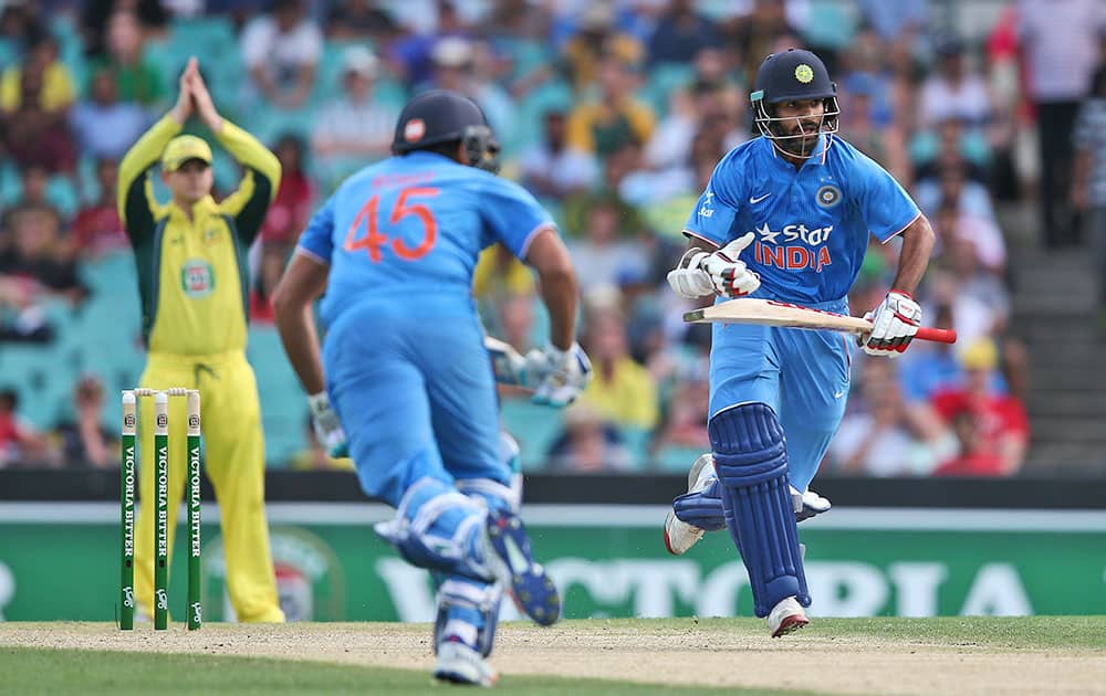 Shikhar Dhawan and Rohit Sharma run between the wicket during their one-day international cricket match against Australia in Sydney.