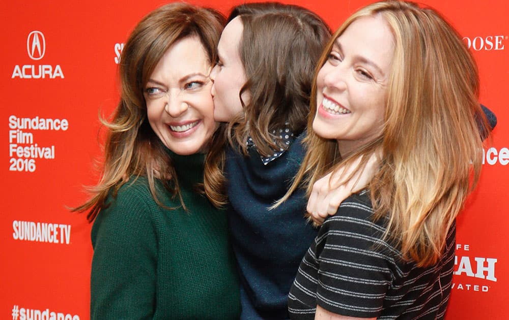 Actress Allison Janney, left, and director and writer Sian Heder, right, pick up actress Ellen Page, center, and Page gives Janney a kiss as they pose at the premiere of 