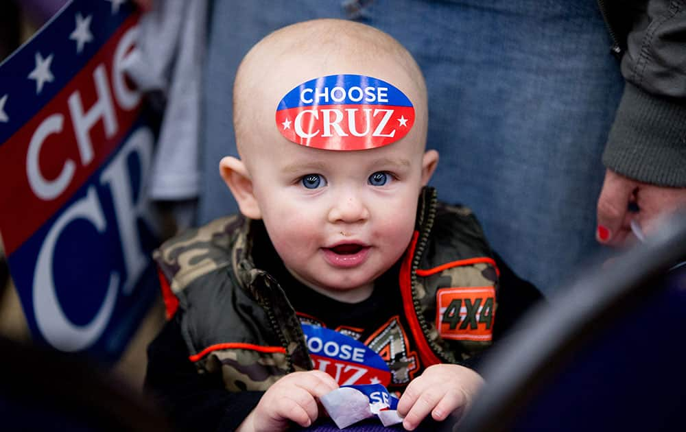 David Cole IV, 1, wears a sticker on his forehead before Republican presidential candidate Sen. Ted Cruz, R-Texas, and Glenn Beck, host a rally at the Five Sullivan Brothers Convention Center in Waterloo, Iowa.