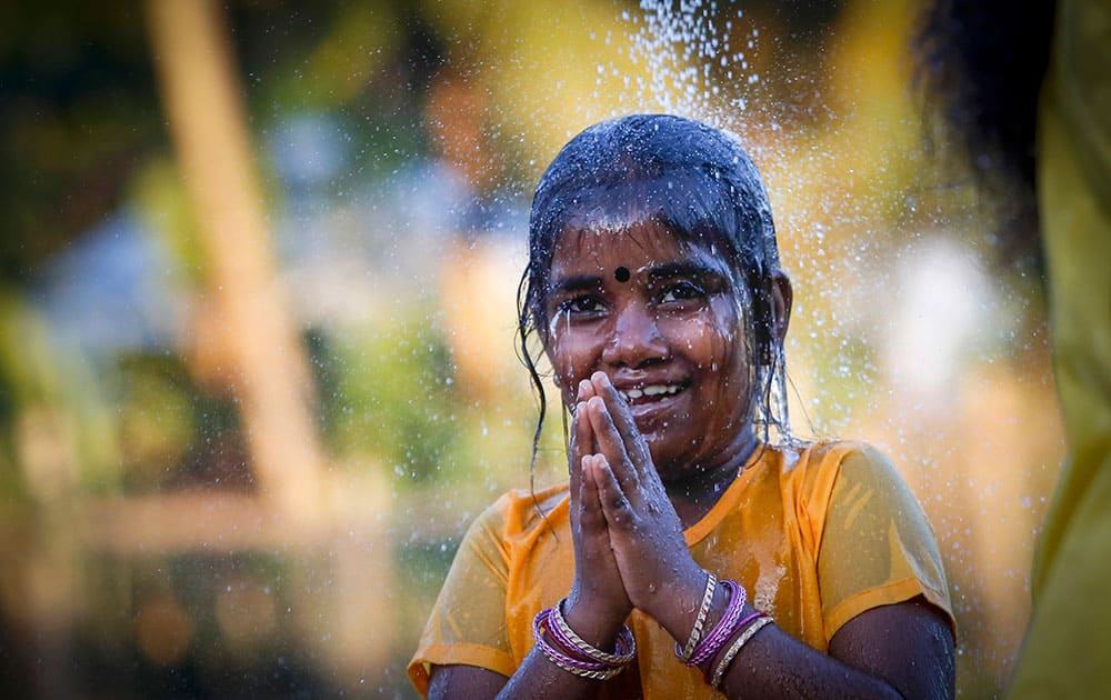 A Hindu devotee girl gets showered as part of a cleaning ritual before her pilgrimage during the Thaipusam festival in Kuala Lumpur, Malaysia.