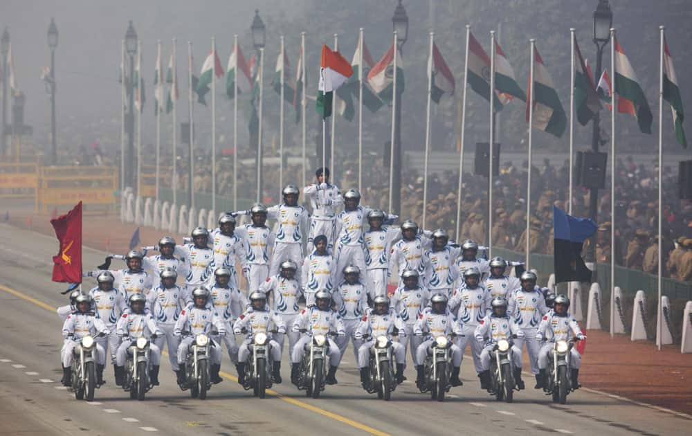 Indian soldiers make formations on motorcycles as they roll down Rajpath during the Republic Day parade in New Delhi.