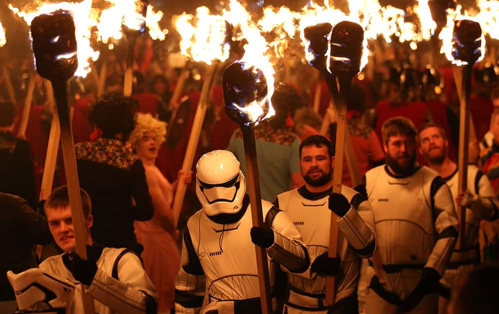 People dressed as Storm Troopers from the Star Wars films carry flaming torches during the Up Helly Aa Viking festival in Lerwick on the Shetland Isles, Scotland.