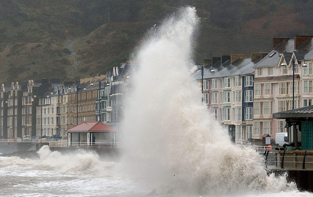 Waves crash against the promenade in Aberystwyth, Wales, as huge swathes of the UK are braced for a deluge of rain.