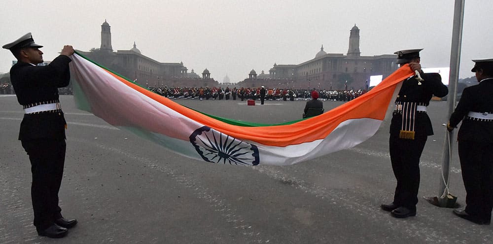 Soldiers folding up the Tri-colour during the full dress rehearsal for the Beating Retreat ceremony, in New Delhi.