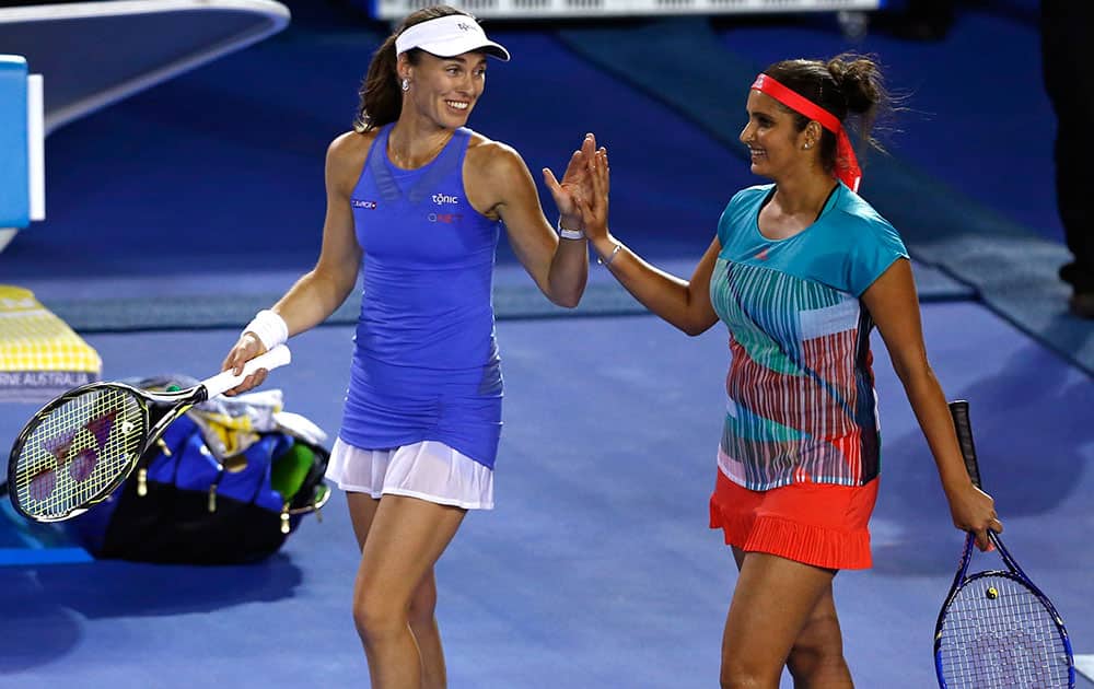 Martina Hingis of Switzerland and Sania Mirza of India celebrate after they defeated Julia Goerges of Germany and Karolina Pliskova of the Czech Republic in their semifinal match at the Australian Open tennis championships in Melbourne, Australia.
