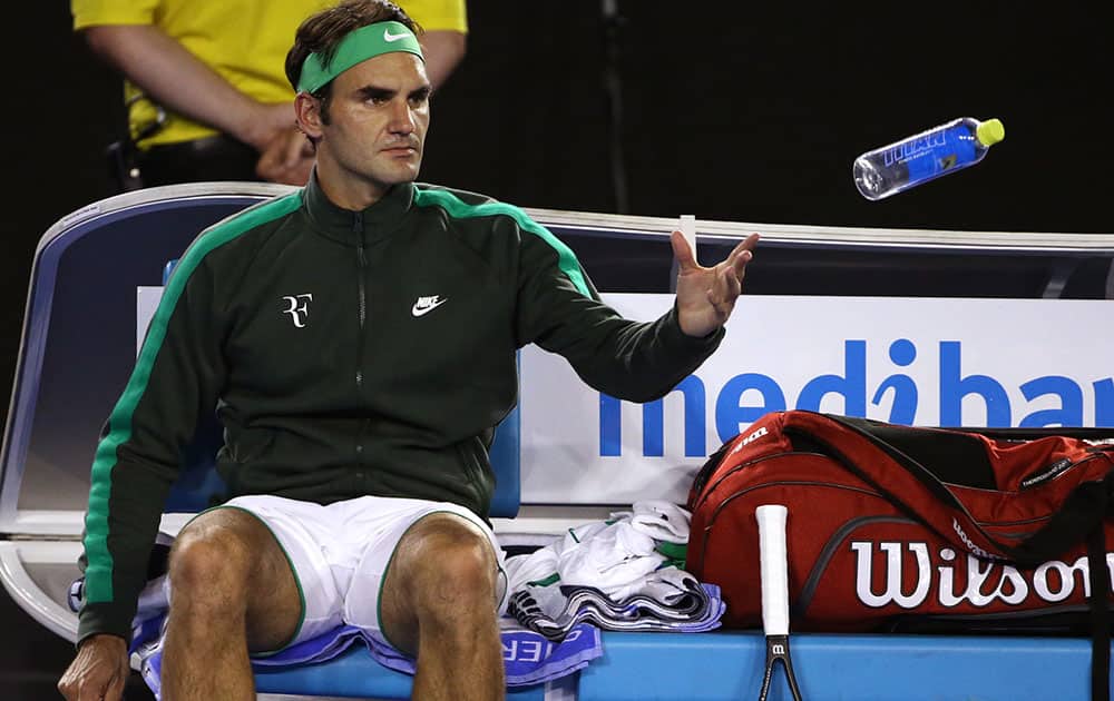 Roger Federer of Switzerland throws his empty water bottle during a break in his semifinal match against Novak Djokovic of Serbia at the Australian Open tennis championships in Melbourne, Australia.