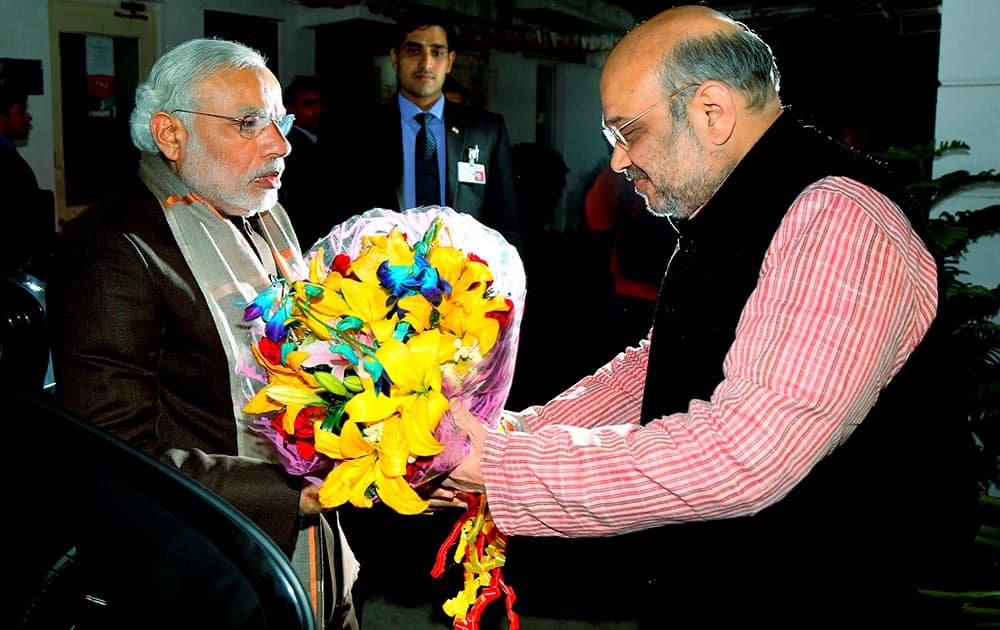 Prime Minister Narendra Modi is received by BJP President Amit Shah as he arrives to attend the partys parliamentary board meeting in New Delhi.