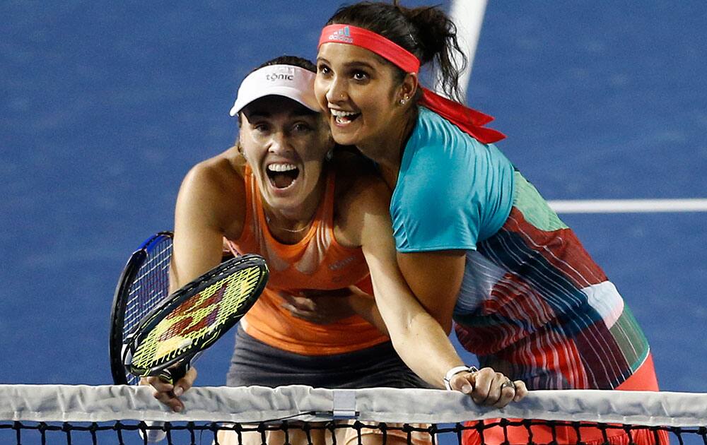 Sania Mirza of India embraces her partner Martina Hingis of Switzerland as they watch a replay on a disputed line call during their match against Czech Republic’s Andrea Hlavackova and Lucie Hradecka in the women's doubles final at the Australian Open tennis championships in Melbourne, Australia.