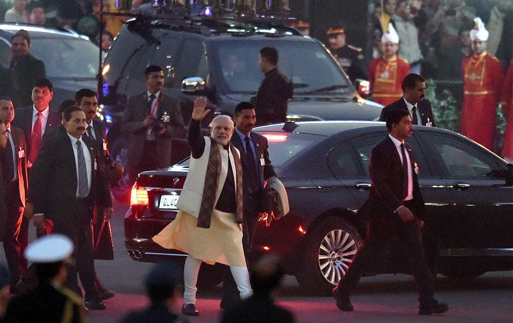 Prime Minister Narendra Modi waves as he leaves after attending the Beating Retreat ceremony at Vijay Chowk in New Delhi.