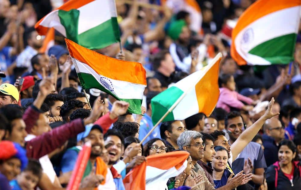 Indian fans wave flags during their T20 cricket match against Australia in Melbourne, Australia.