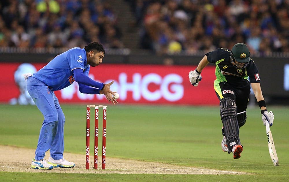  Yuvraj Singh, left, attempts to run out Australia's Shane Watson during their T20 cricket match against Australia in Melbourne, Australia.