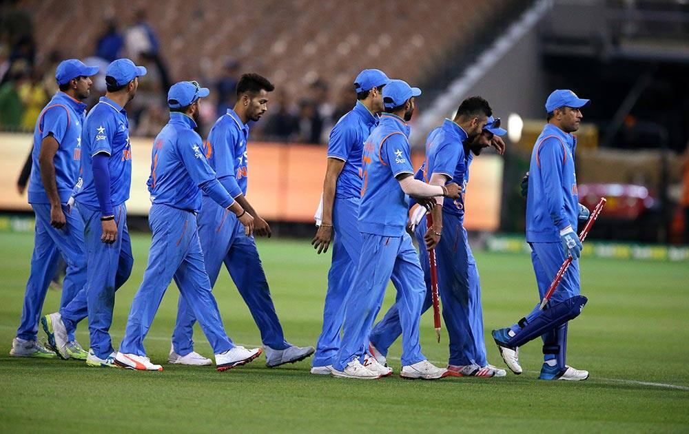 Teammates walk off after defeating Australia in their T20 cricket match in Melbourne.