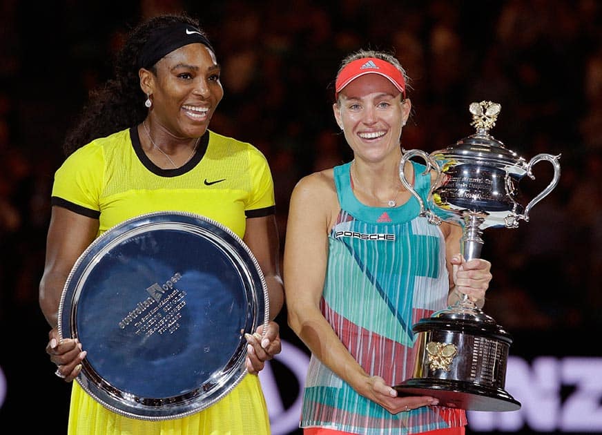 Angelique Kerber, of Germany holds the trophy, along with runner-up Serena Williams of the United States after the womens singles final at the Australian Open tennis championships in Melbourne.