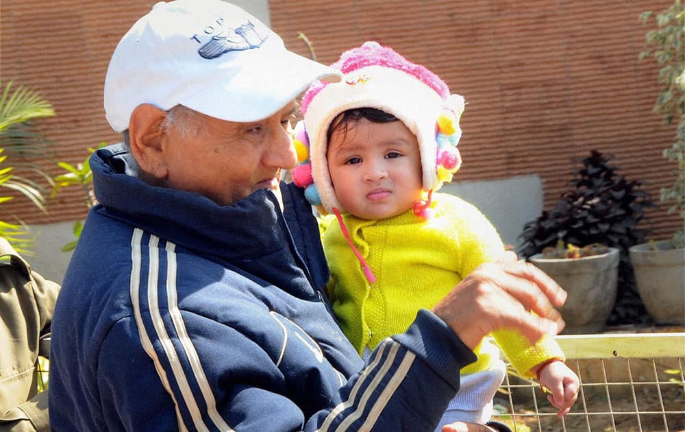 Indian cricket team skipper Mahendra Singh Dhonis daughter Ziva with grandfather Pan Singh at heir residence in Ranchi.