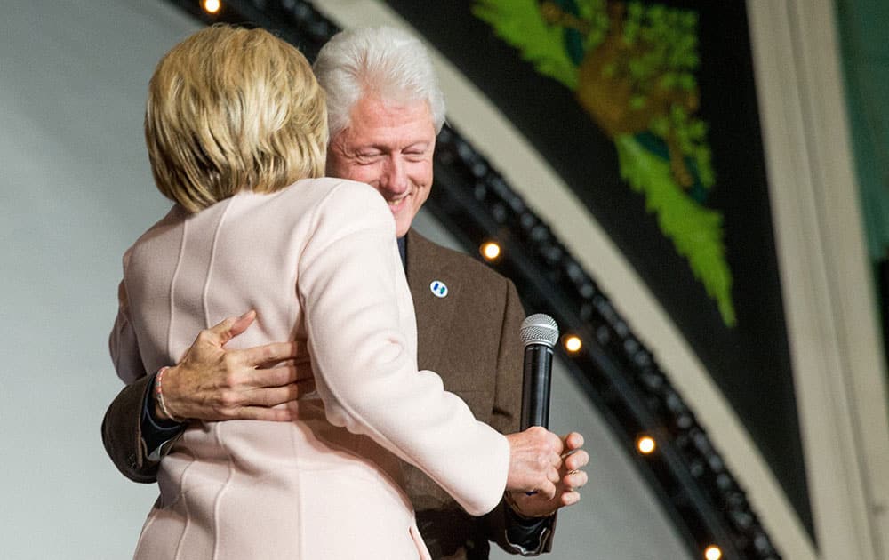 Democratic presidential candidate Hillary Clinton hugs her husband former President Bill Clinton as she takes the stage to speak at a rally at the Col Ballroom in Davenport, Iowa.