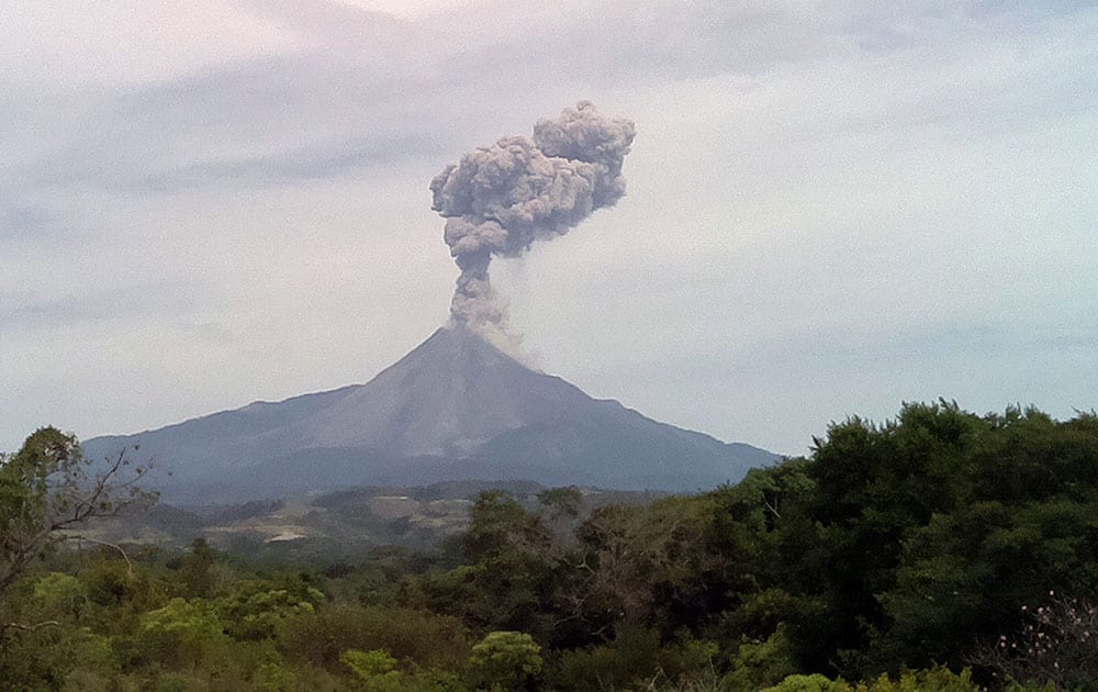 A large plume of ash rises from the crater of the Colima volcano, also known as the 