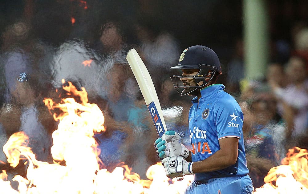 Indian batsmen Rohit Sharma walks onto the field during their T20 International cricket match against Australia in Sydney, Australia.