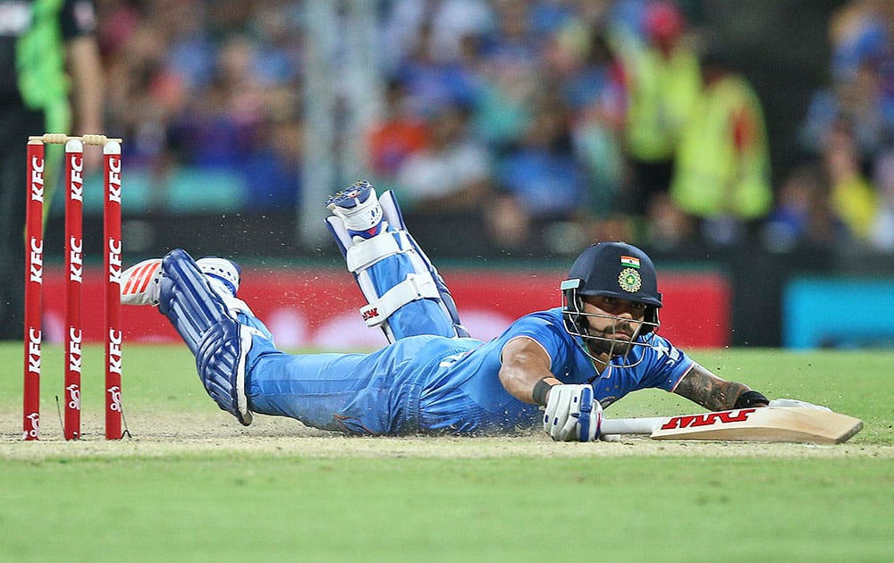 India's Virat Kohli dives into his crease after taking a quick single during their T20 International cricket match against Australia in Sydney, Australia.