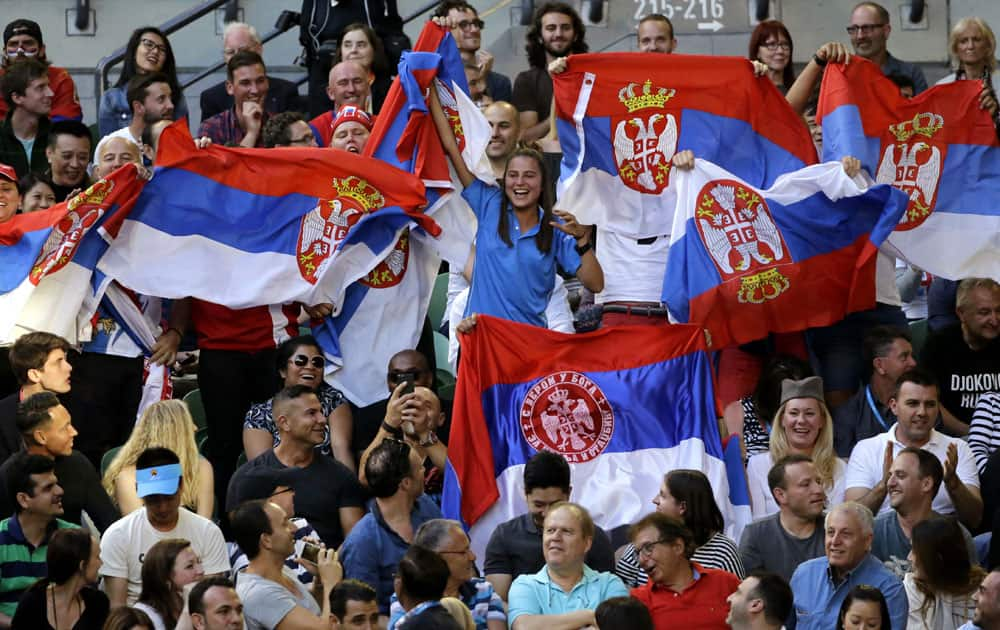 Supporters of Novak Djokovic of Serbia cheer him on in his men's singles final match against Andy Murray of Britain at the Australian Open tennis championships in Melbourne.