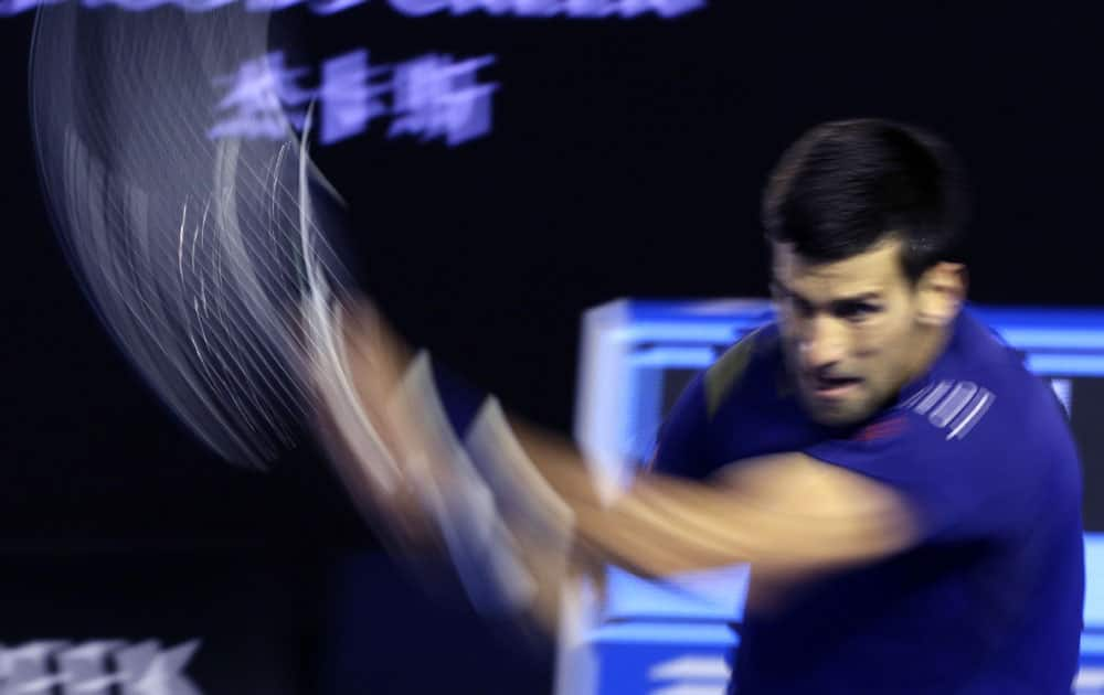 Novak Djokovic of Serbia plays a backhand return to Andy Murray of Britain during the men's singles final at the Australian Open tennis championships in Melbourne.