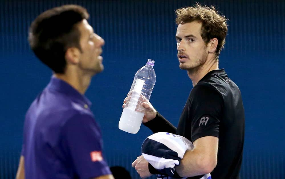 Andy Murray, right, of Britain watches as Novak Djokovic of Serbia changes ends during the men's singles final at the Australian Open tennis championships in Melbourne.