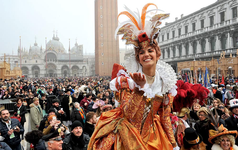 Irene Rizzi blows a kiss after descending from the bell tower into St. Mark's Square, in Venice.