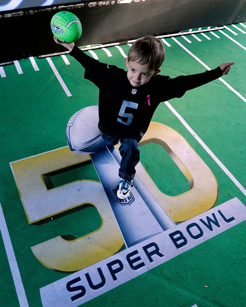Ethan Kalabolas, age 5, plays at an attraction at Super Bowl City in San Francisco. 