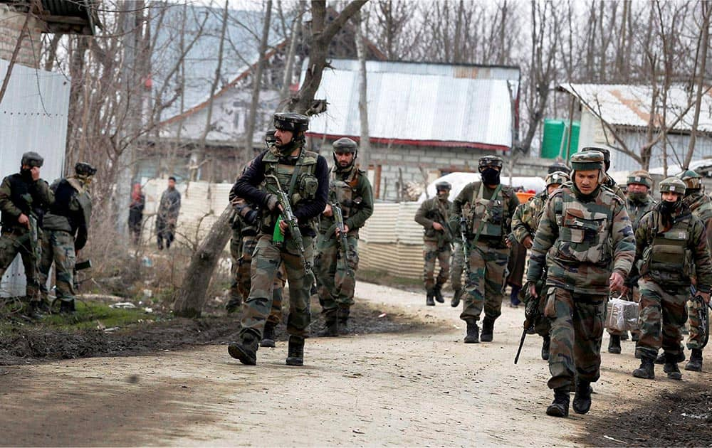 Army personnel moving towards a house where militants were reportedly holed up during an encounter at the Hajin area of Bandipora district in north Kashmir.