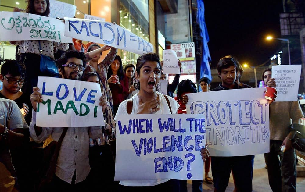 Students from different colleges hold placards and Candles during a protest against the attack on a Tanzanian Girl by a mob in Bengaluru.