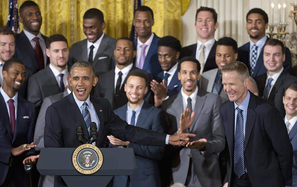 President Barack Obama points to Golden State Warriors head basketball coach Steve Kerr, right, during a ceremony in the East Room of the White House in Washington.