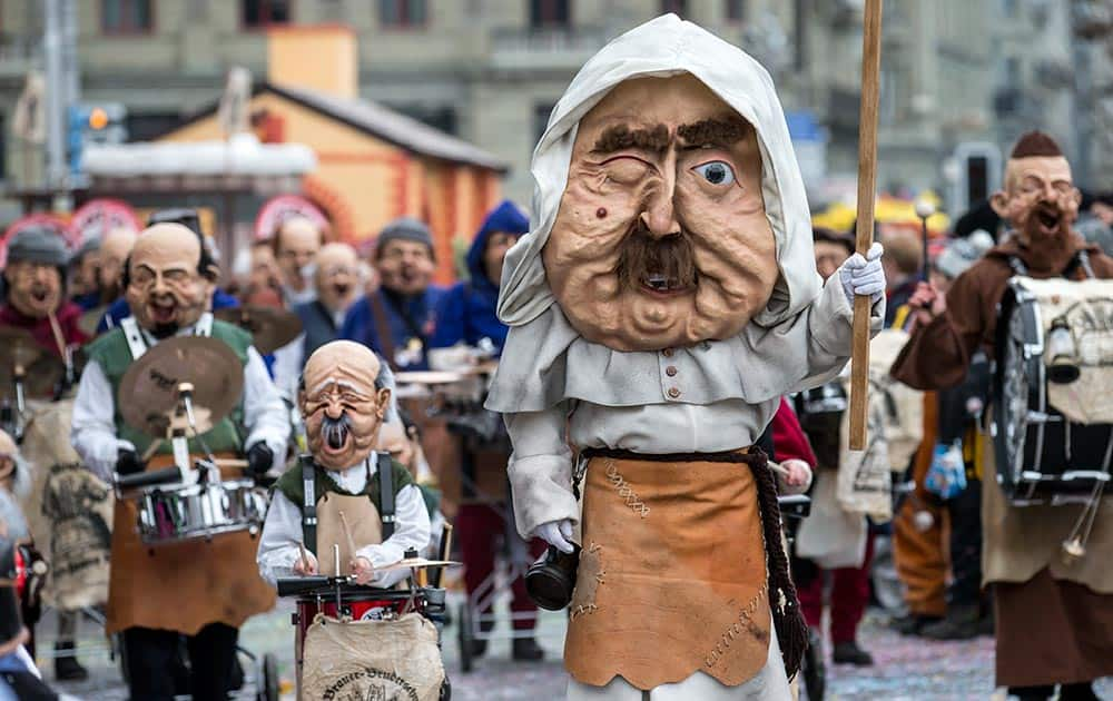 Costumed members of a carnival band participate in the carnival parade in the historic center of Lucerne, Switzerland.