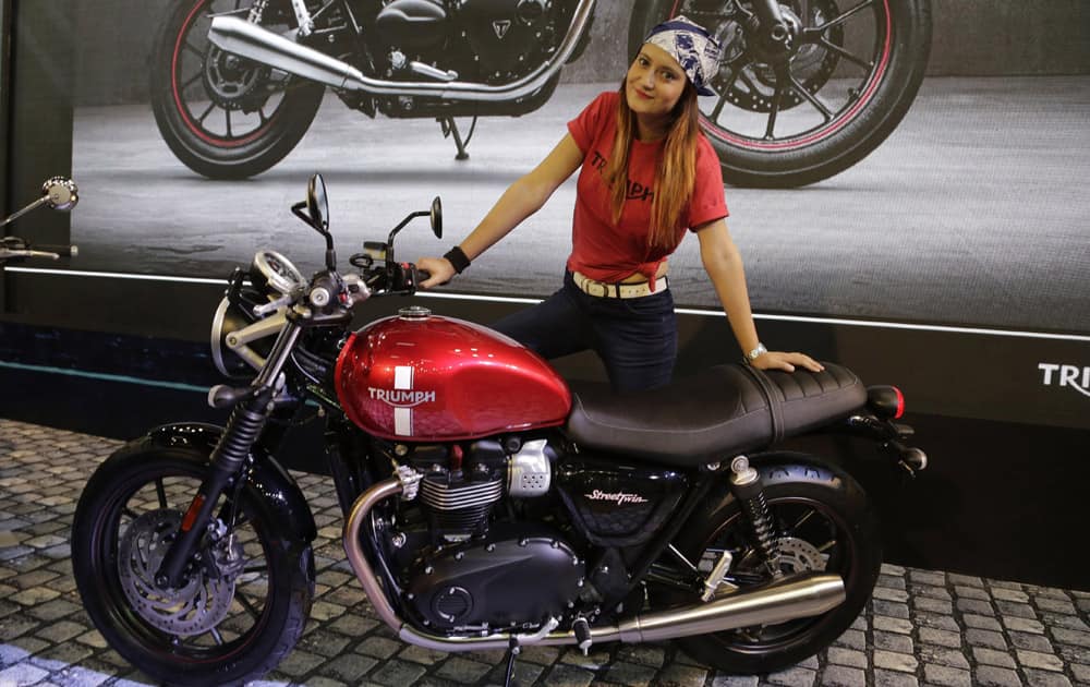 A model poses with Triumph's 900cc Street Twin motorcycle at the Auto Expo in Greater Noida, near New Delhi.